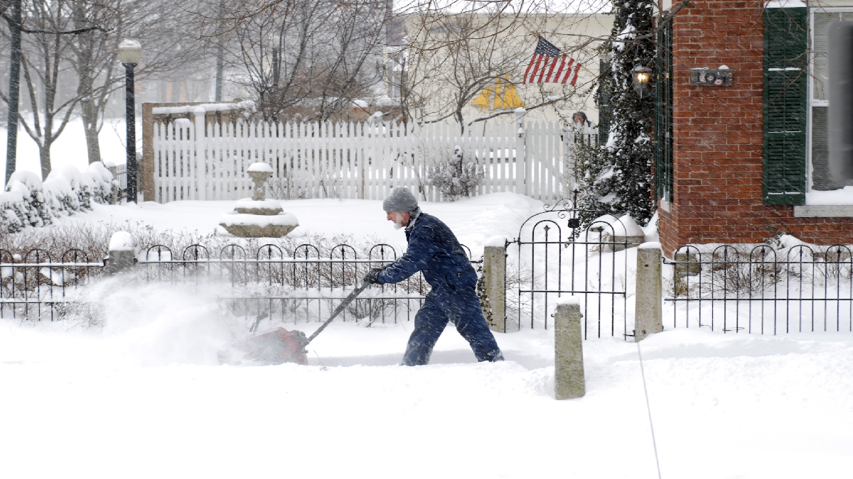 Man/house owner shoveling snow