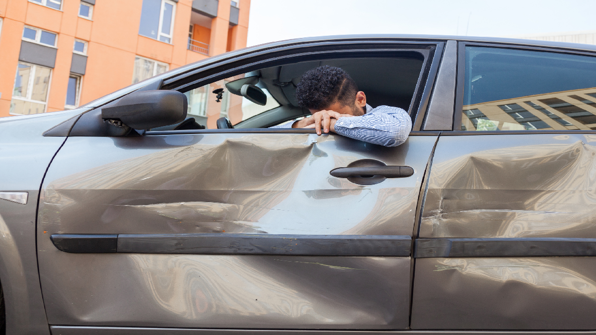 Man frustrated because his car is crashed