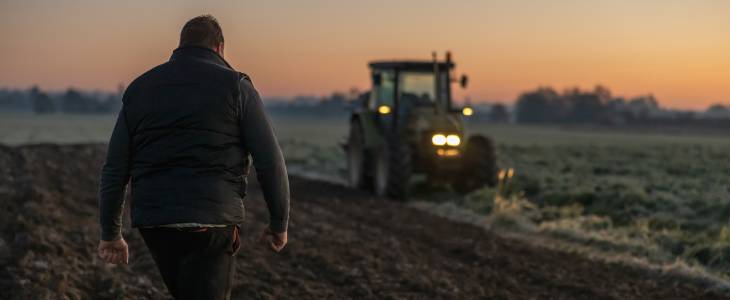 Farmer working late on field