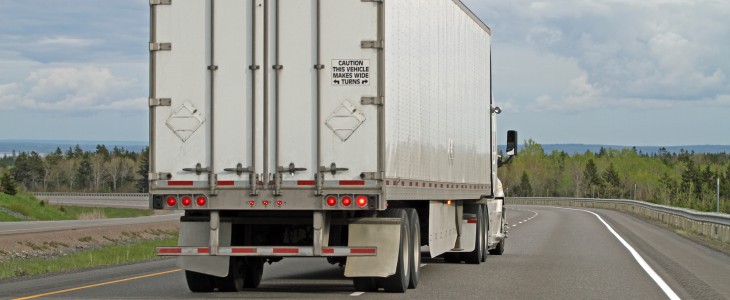 A truck driving down an isolated road