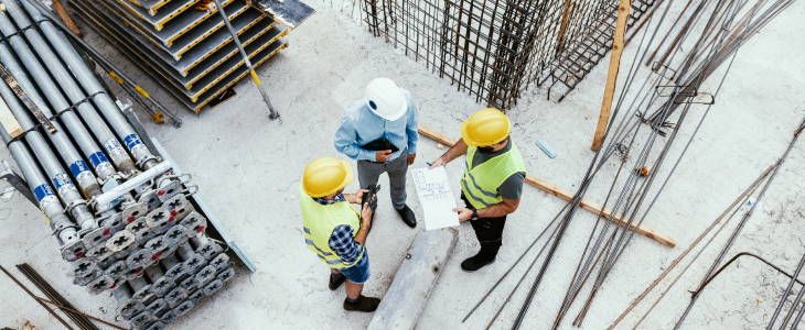 Construction site workers talking about a project