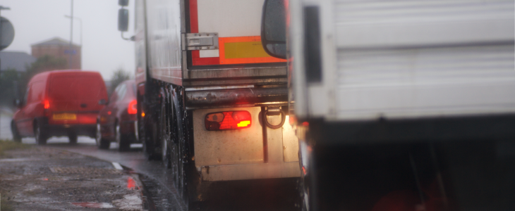 Trucks on a stop at a light during inclement weather