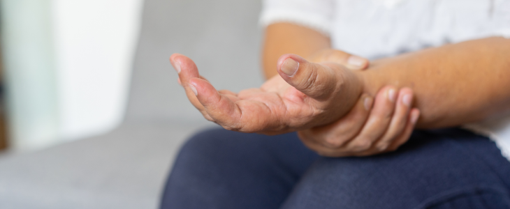 Women holding her wrist due to a repetitive motion injury.