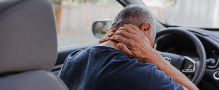 man holding his neck after a rear-end accident