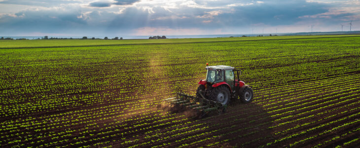 Tractor cultivating field at spring,aerial view