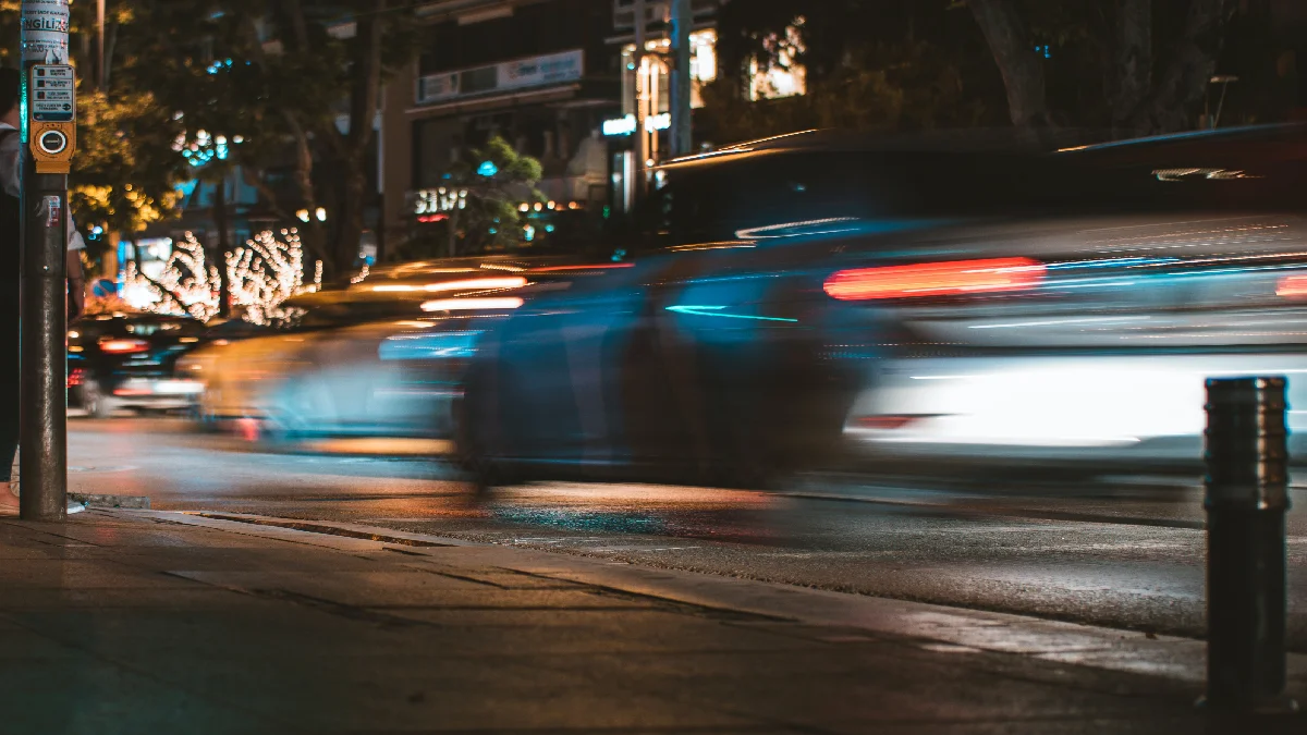 Cars speeding on road.