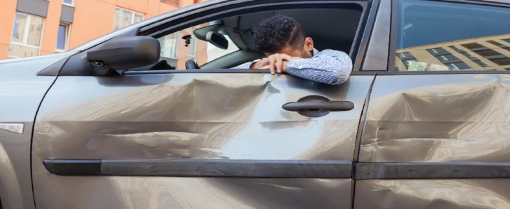 Man frustrated because his car is crashed