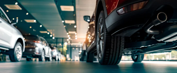 Row of cars inside a dealership showroom in North Dakota, related to personal injury attorney