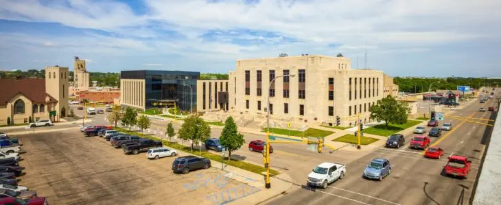 Busy street scene by modern and historic buildings in Minot, ND.